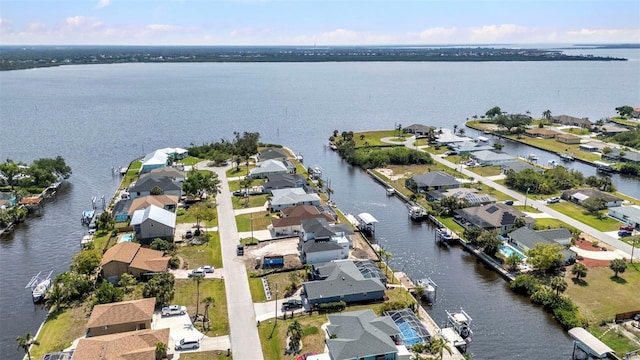 drone / aerial view with a residential view and a water view