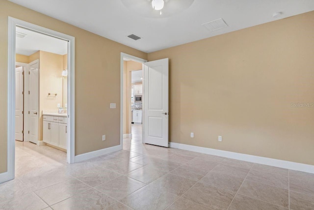 1352 Raspberry Dr, North Port, FL 34289 - unfurnished bedroom with light tile patterned floors, ensuite bathroom, and ceiling fan
