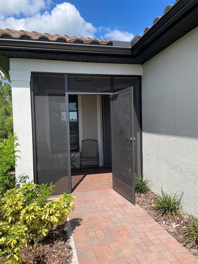 1352 Raspberry Dr, North Port, FL 34289 - property entrance featuring stucco siding and a tile roof