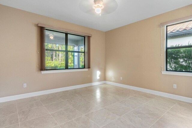1352 Raspberry Dr, North Port, FL 34289 - tiled empty room with a ceiling fan and baseboards