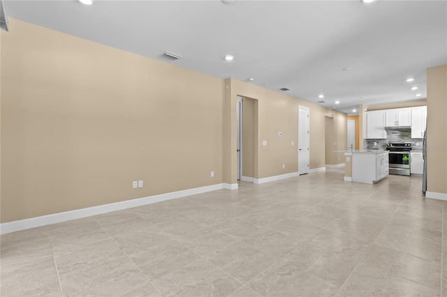 1352 Raspberry Dr, North Port, FL 34289 - unfurnished living room with recessed lighting and baseboards