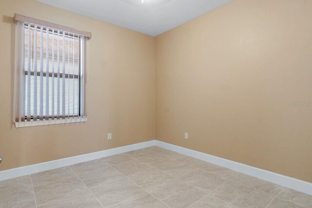 1352 Raspberry Dr, North Port, FL 34289 - unfurnished room with baseboards and light tile patterned floors