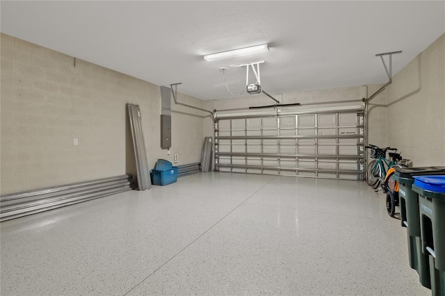 1352 Raspberry Dr, North Port, FL 34289 - garage with a garage door opener, electric panel, and concrete block wall