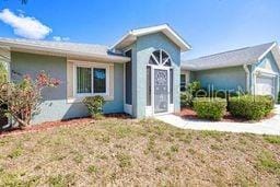 23482 Moreland Ave, Port Charlotte, FL 33954 - view of front of home featuring stucco siding and a garage