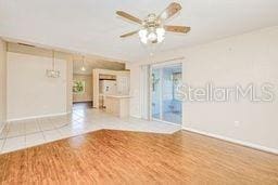 23482 Moreland Ave, Port Charlotte, FL 33954 - empty room featuring baseboards, ceiling fan, and wood finished floors