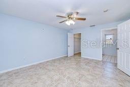 23482 Moreland Ave, Port Charlotte, FL 33954 - unfurnished bedroom featuring baseboards and a ceiling fan