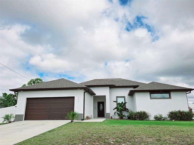 1819 NW 21st St, Cape Coral, FL 33993 - prairie-style house with concrete driveway, stucco siding, an attached garage, a front yard, and a shingled roof
