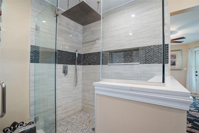 bathroom featuring a stall shower and a ceiling fan