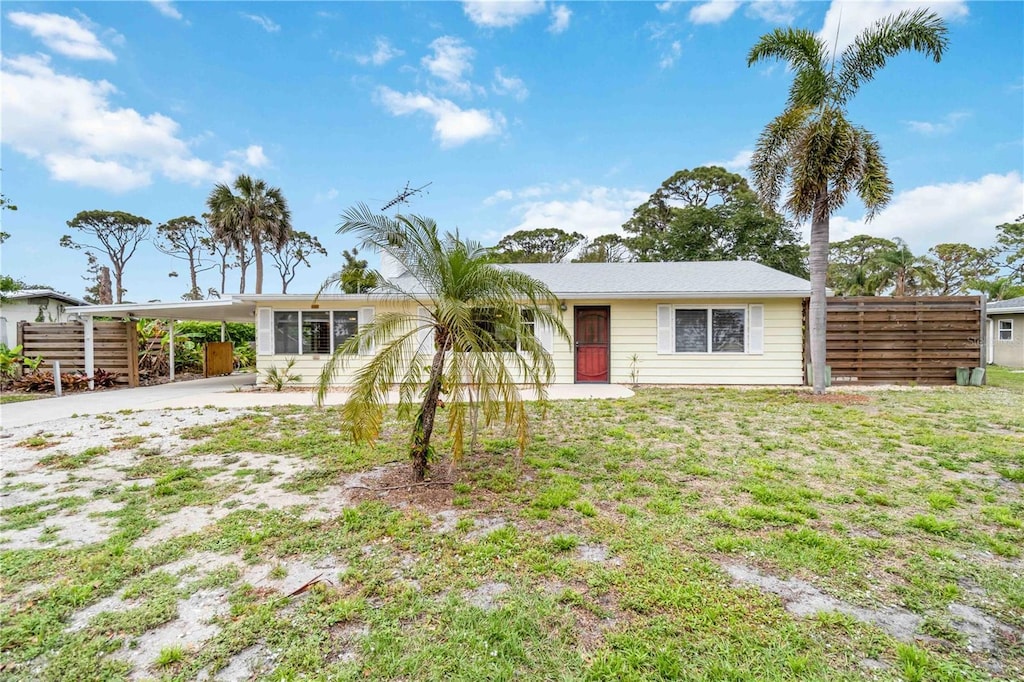 217 Palm Ave E, Nokomis, FL 34275 - single story home featuring concrete driveway and a carport