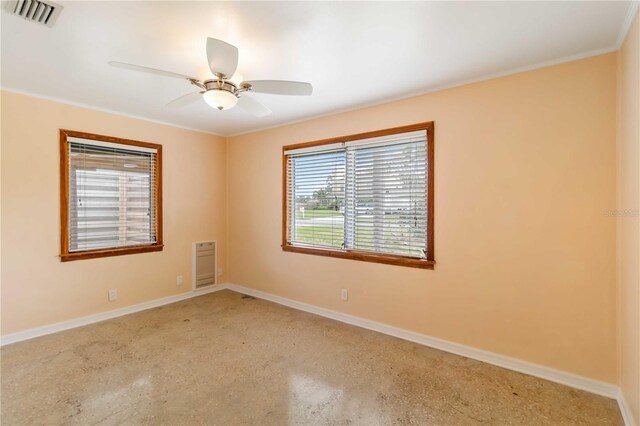 217 Palm Ave E, Nokomis, FL 34275 - unfurnished room featuring heating unit, baseboards, ceiling fan, crown molding, and speckle patterned floor