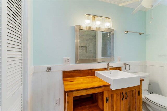 217 Palm Ave E, Nokomis, FL 34275 - full bathroom with toilet, vanity, wainscoting, a closet, and ornamental molding