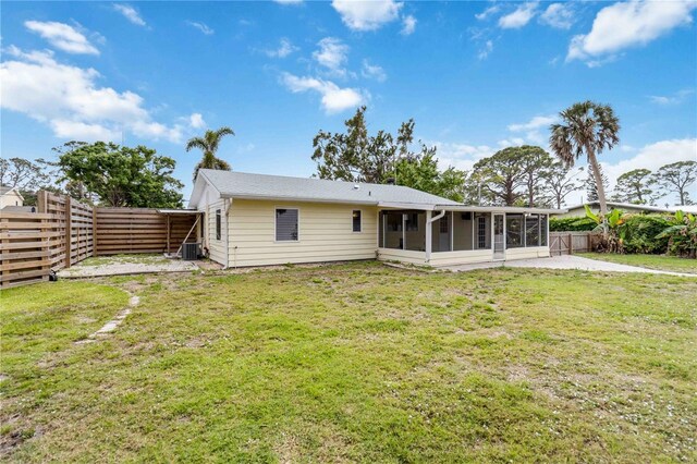 217 Palm Ave E, Nokomis, FL 34275 - back of property featuring a sunroom and central AC
