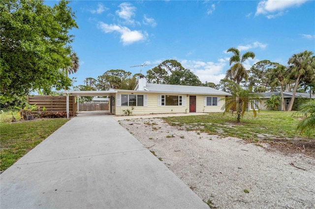 217 Palm Ave E, Nokomis, FL 34275 - single story home with driveway, an attached carport, and a chimney