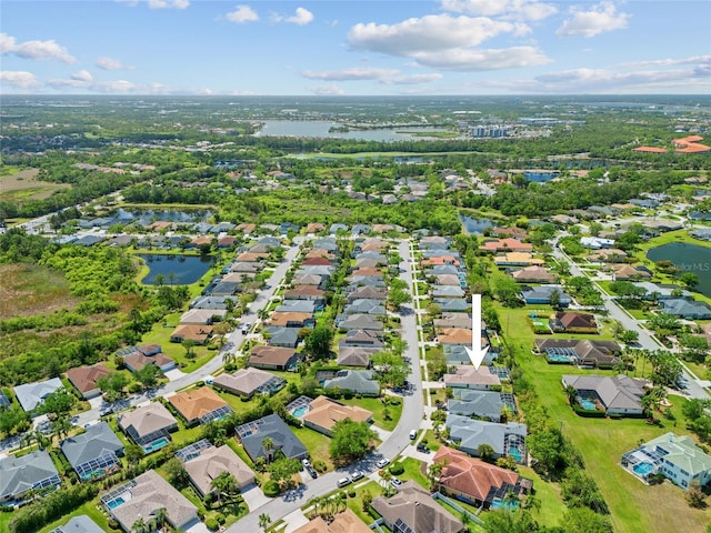 bird's eye view featuring a residential view and a water view