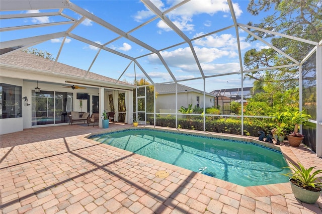 pool featuring a lanai, a patio, and ceiling fan