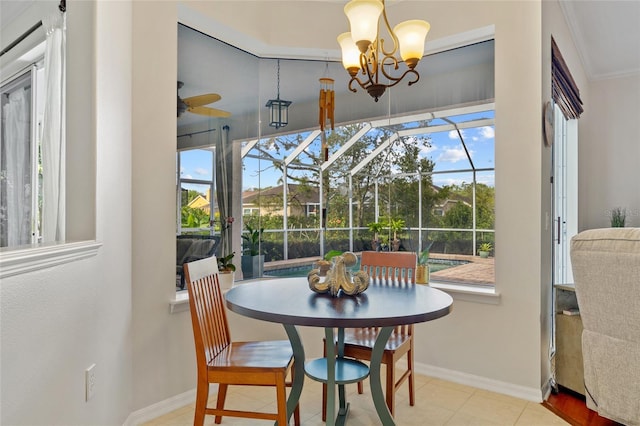 dining area with ornamental molding, baseboards, a sunroom, and ceiling fan with notable chandelier
