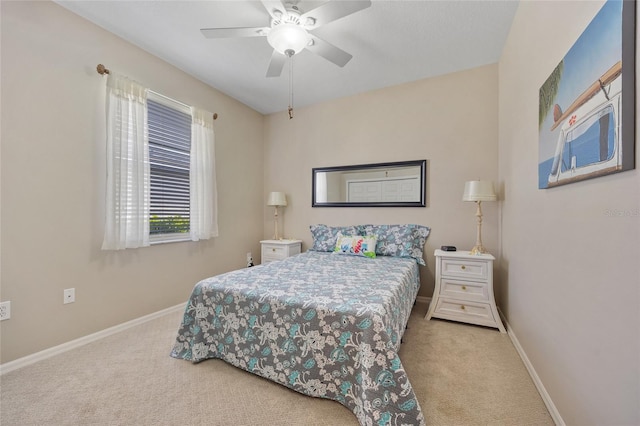 carpeted bedroom with baseboards and a ceiling fan