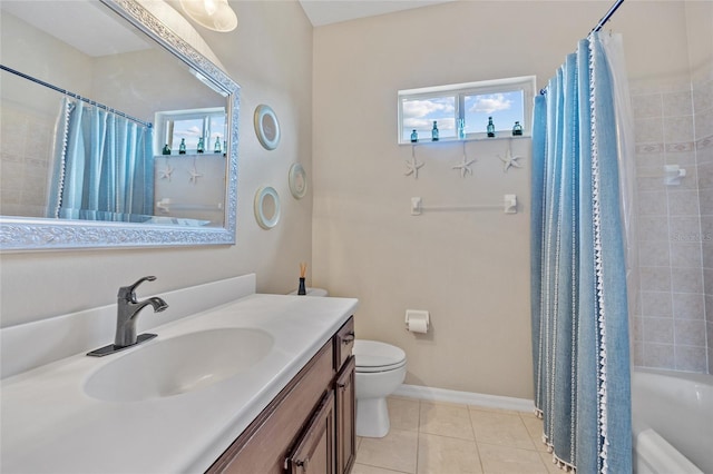 bathroom with vanity, toilet, tile patterned flooring, and a healthy amount of sunlight