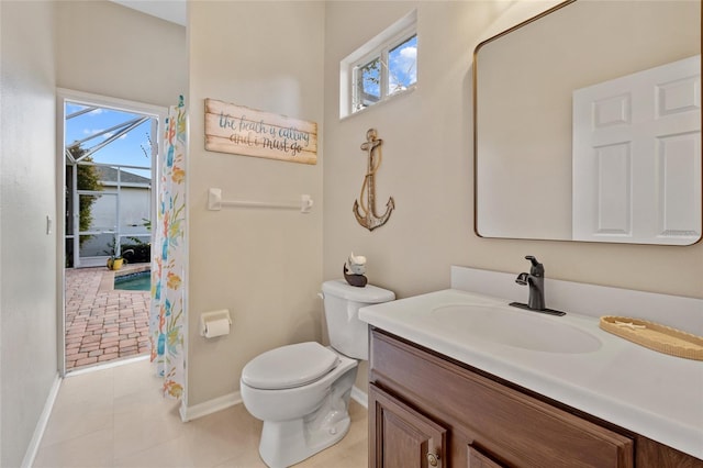bathroom with tile patterned floors, toilet, vanity, and baseboards