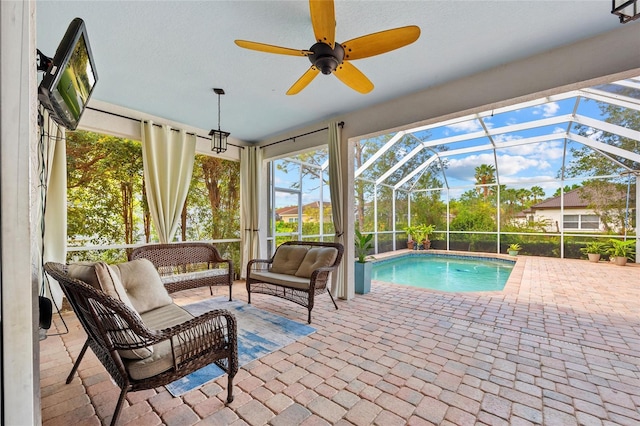 outdoor pool featuring an outdoor living space, a patio, ceiling fan, and a lanai