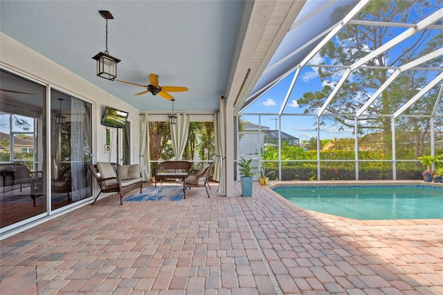 pool with a lanai, a patio area, a ceiling fan, and an outdoor hangout area