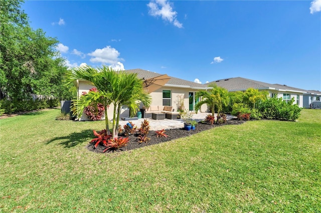 rear view of house with outdoor lounge area, stucco siding, a yard, and a patio area