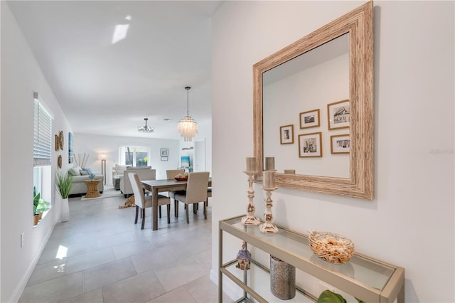 dining space featuring light tile patterned flooring and baseboards