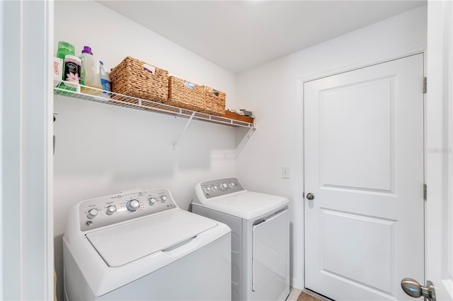 laundry room featuring separate washer and dryer and laundry area