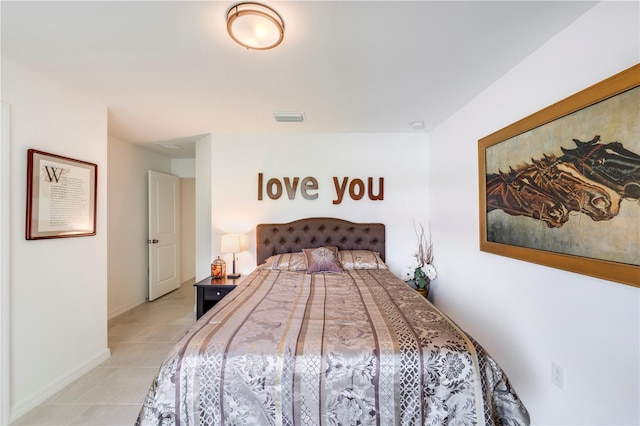 bedroom featuring baseboards, visible vents, and light tile patterned floors