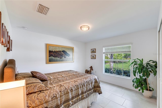 bedroom featuring visible vents and light tile patterned floors