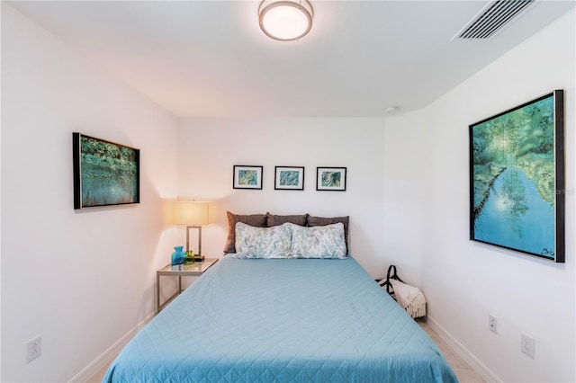 bedroom featuring baseboards and visible vents