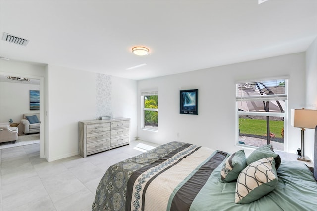 bedroom featuring tile patterned floors, baseboards, and visible vents