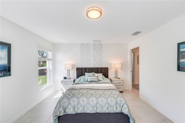 bedroom featuring baseboards and visible vents