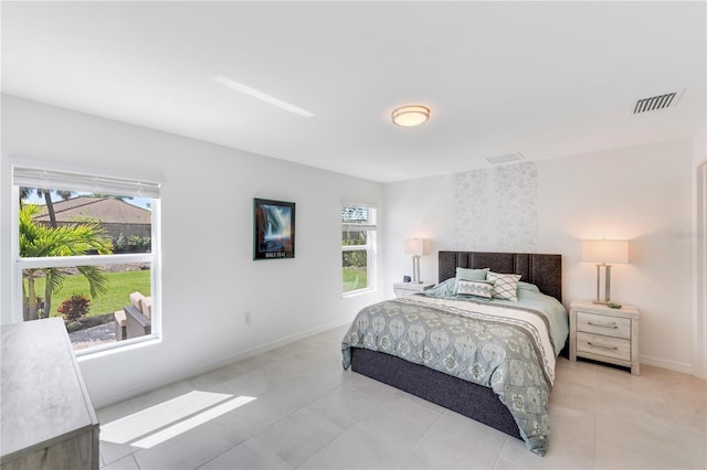 tiled bedroom featuring baseboards and visible vents