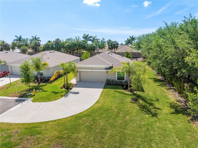 ranch-style home featuring a garage, a front yard, concrete driveway, and stucco siding