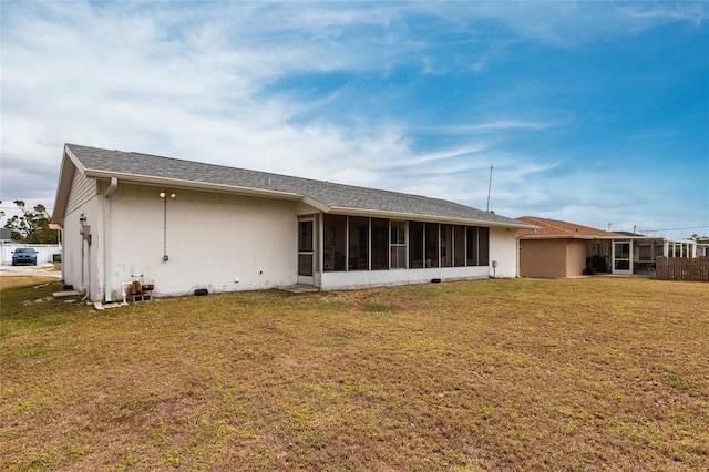 3249 Sunrise Trl, Port Charlotte, FL 33952 - back of house with a lawn, stucco siding, and a sunroom