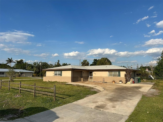 134 Peace Island Dr, Punta Gorda, FL 33950 - ranch-style house with fence, a garage, stucco siding, a front yard, and driveway