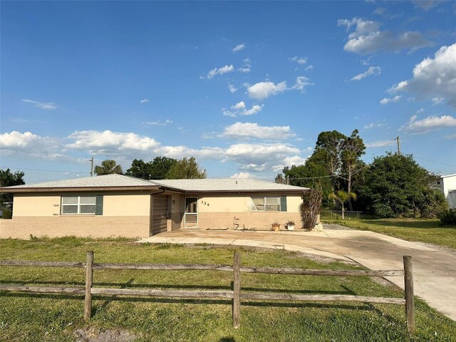 134 Peace Island Dr, Punta Gorda, FL 33950 - single story home with a front lawn, a fenced front yard, and brick siding