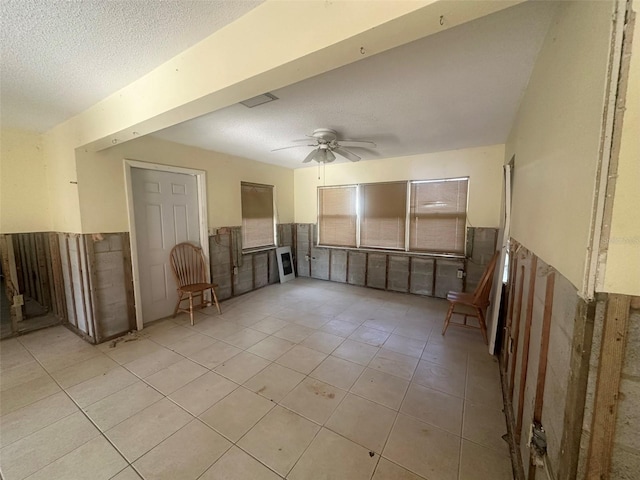 134 Peace Island Dr, Punta Gorda, FL 33950 - unfurnished room with a wainscoted wall, light tile patterned flooring, a textured ceiling, visible vents, and ceiling fan