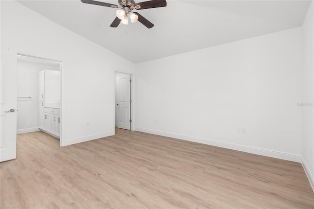 2300 Nordendale Blvd, North Port, FL 34288 - unfurnished bedroom with lofted ceiling, light wood-style floors, baseboards, a ceiling fan, and connected bathroom