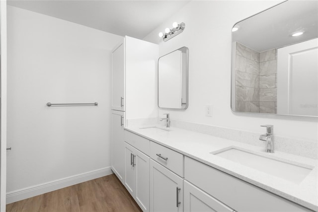 2300 Nordendale Blvd, North Port, FL 34288 - bathroom with double vanity, wood finished floors, and baseboards