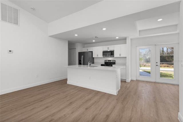 2300 Nordendale Blvd, North Port, FL 34288 - kitchen featuring appliances with stainless steel finishes, white cabinets, light wood finished floors, baseboards, and light countertops