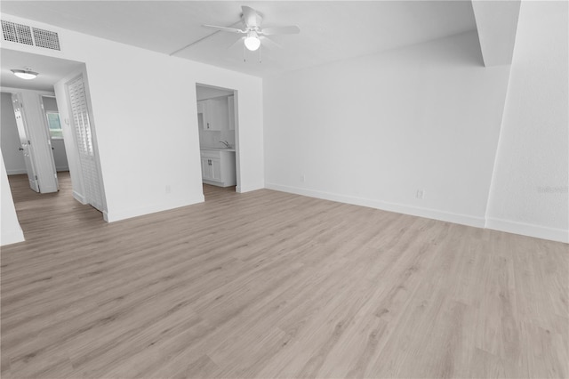6500 Estero Blvd Unit F116, Fort Myers Beach, FL 33931 - unfurnished living room with ceiling fan and light wood finished floors