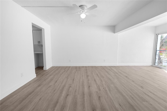 6500 Estero Blvd Unit F116, Fort Myers Beach, FL 33931 - unfurnished living room featuring ceiling fan and light wood finished floors