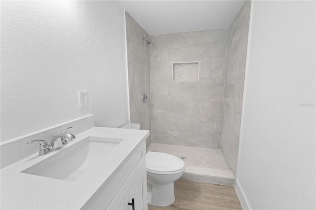 6500 Estero Blvd Unit F116, Fort Myers Beach, FL 33931 - full bath with tiled shower, vanity, and wood finished floors