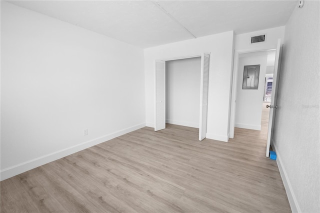 6500 Estero Blvd Unit F116, Fort Myers Beach, FL 33931 - unfurnished bedroom with wood finished floors, a closet, and electric panel