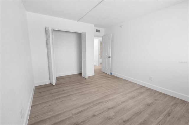 6500 Estero Blvd Unit F116, Fort Myers Beach, FL 33931 - unfurnished bedroom with a closet and wood finished floors
