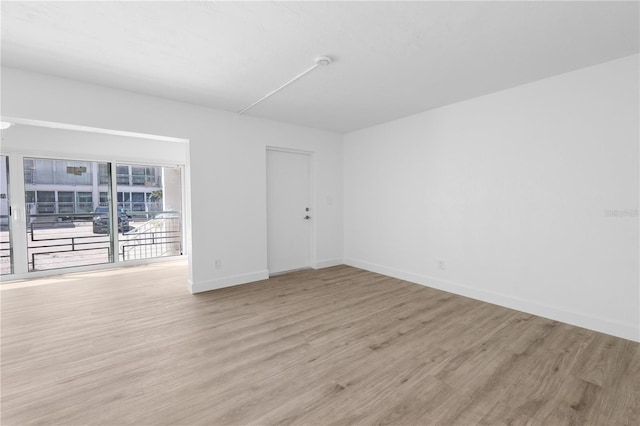 6500 Estero Blvd Unit F116, Fort Myers Beach, FL 33931 - unfurnished room featuring wood finished floors and a smoke detector