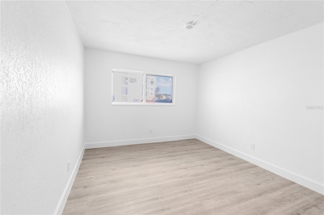 6500 Estero Blvd Unit F116, Fort Myers Beach, FL 33931 - unfurnished room featuring light wood-style flooring and a smoke detector
