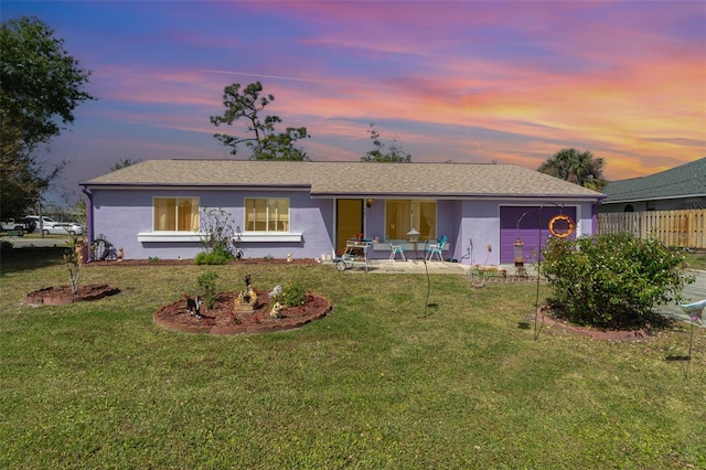 402 Cicero St NW, Port Charlotte, FL 33948 - view of front of home featuring a lawn, stucco siding, and fence